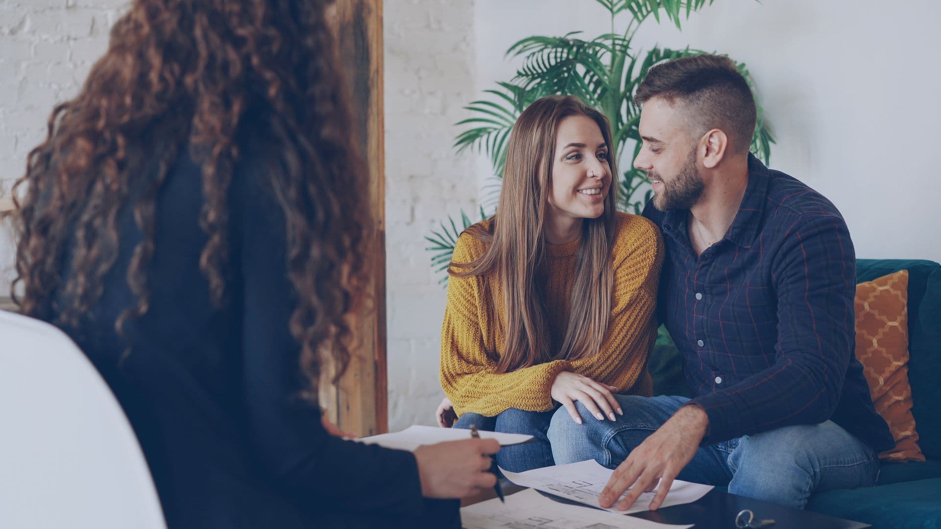 A young couple smiles at each other in a doctor’s office